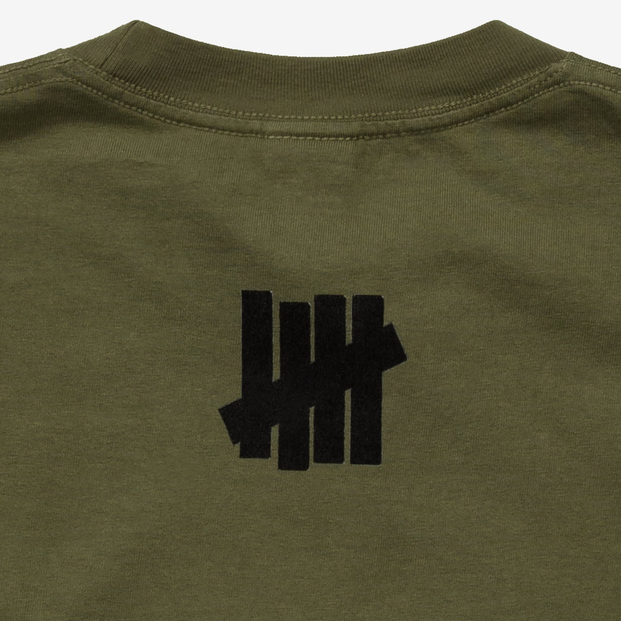 Olive green Undefeated Stencil Logo Tee displayed flat, showcasing the classic logo design on soft cotton fabric.
