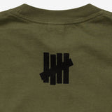 Olive green Undefeated Stencil Logo Tee displayed flat, showcasing the classic logo design on soft cotton fabric.