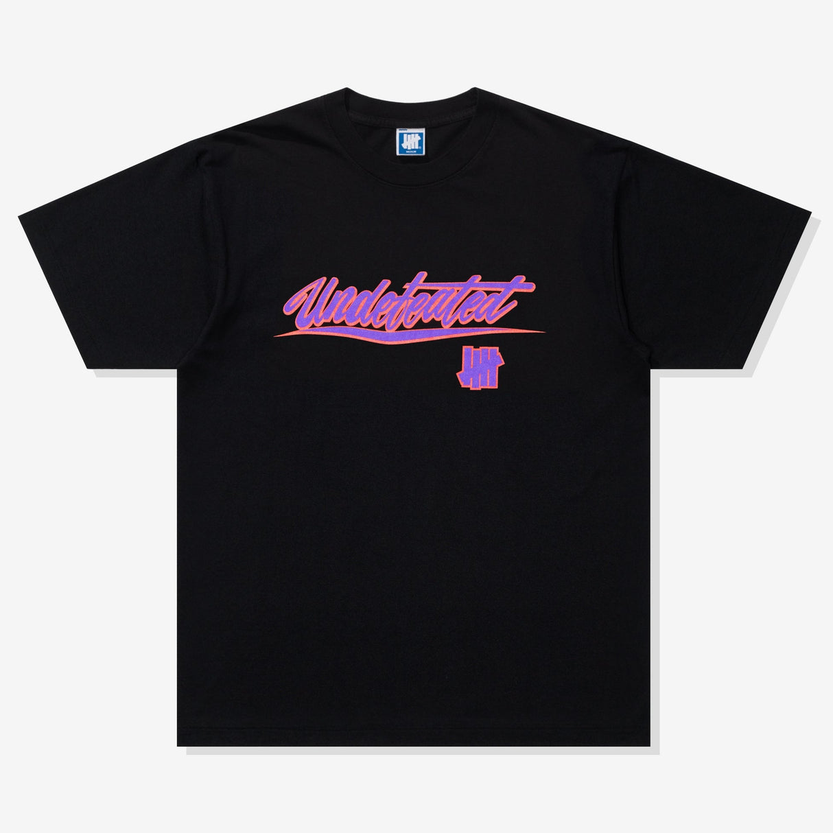 Black Undefeated Wrap Tee shirt featuring a relaxed fit, displayed on a hanger with a plain background.