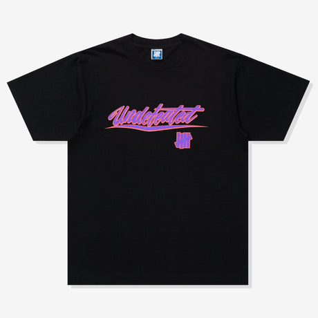 Black Undefeated Wrap Tee shirt featuring a relaxed fit, displayed on a hanger with a plain background.