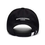 Black Wooyoungmi WYM logo cap, stylish headwear with embroidered branding, adjustable strap, and classic design.