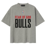 Fear of God Essentials x Chicago Bulls NBA 90s Heavyweight Tee in concrete, unisex apparel with vintage basketball team design.