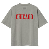 Fear of God Essentials NBA Chicago Bulls 90s heavyweight unisex T-shirt in concrete with Bulls logo and vintage style.