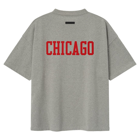 Fear of God Essentials NBA Chicago Bulls 90s heavyweight unisex T-shirt in concrete with Bulls logo and vintage style.