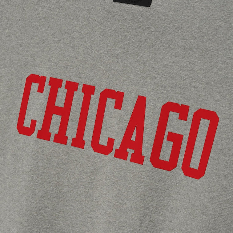 Fear of God Essentials X Chicago Bulls NBA 90s Heavyweight Tee in concrete, unisex apparel with Chicago Bulls logo and vintage NBA design.