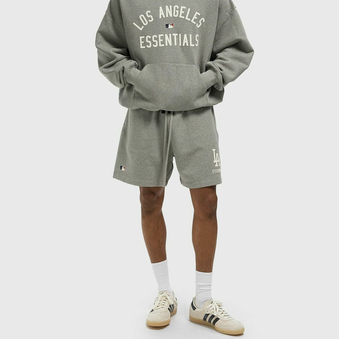 Fear Of God Essentials X LA Dodgers sweat shorts in concrete heather, casual athletic apparel with branded logo and relaxed fit.