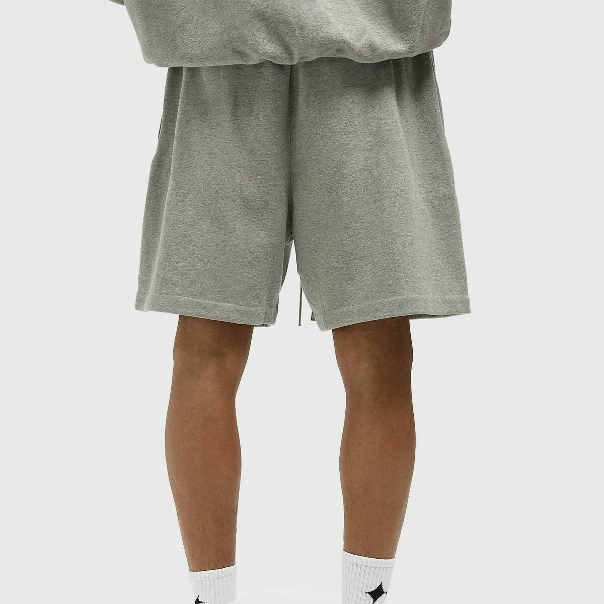 Fear Of God Essentials X LA Dodgers sweat shorts in concrete heather fabric, casual athletic style with brand and team details.