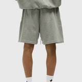 Fear Of God Essentials X LA Dodgers sweat shorts in concrete heather fabric, casual athletic style with brand and team details.