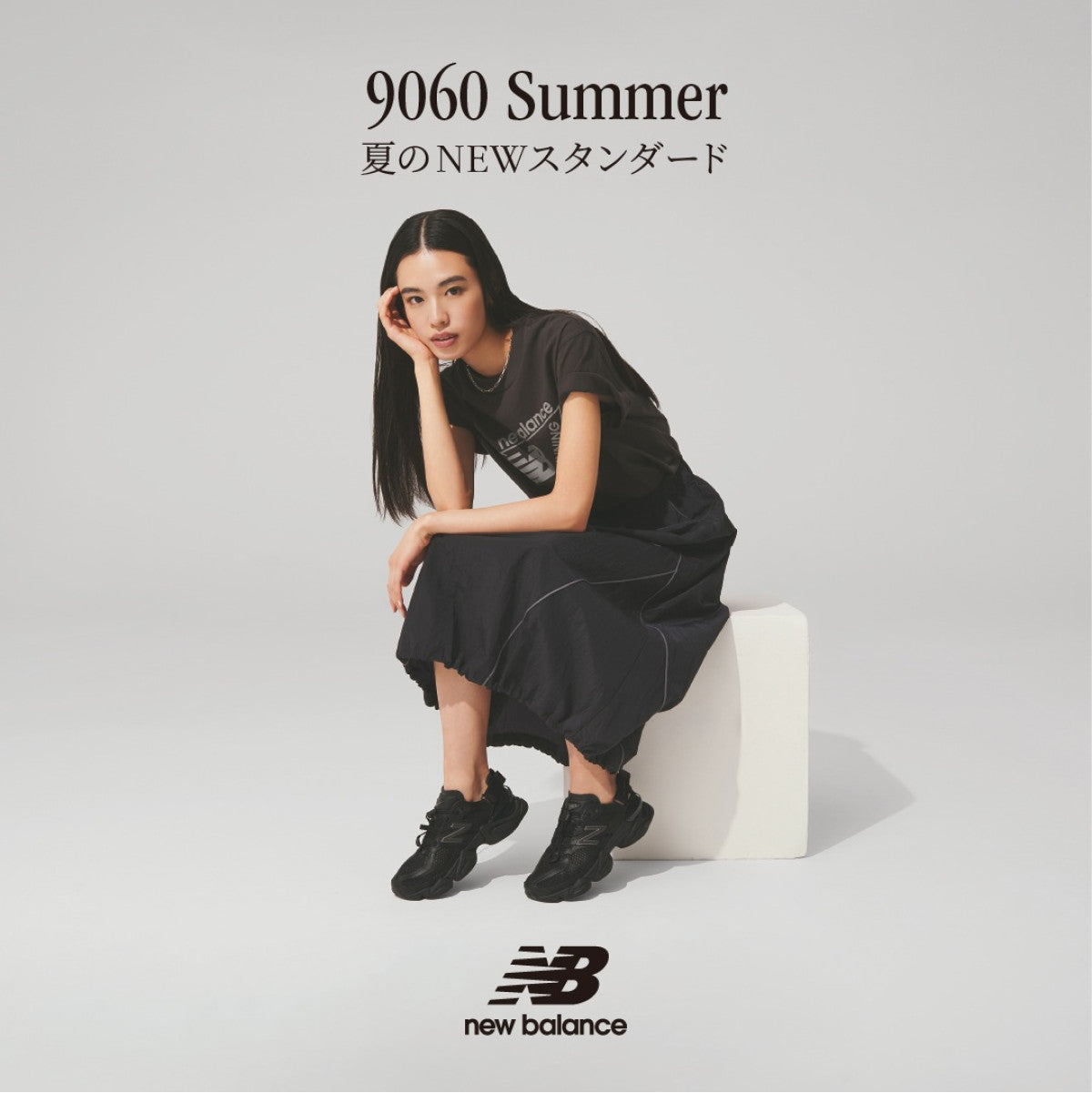 Black New Balance 9060 Mule sneakers with sleek design and cushioned sole, featured in a close-up image.