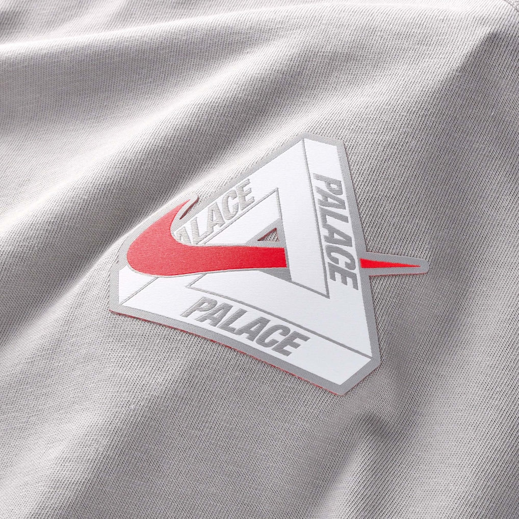 Nike Palace x England T-shirt in pewter grey, featuring England branding and a comfortable fit, worn by a person.