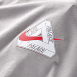 Nike Palace x England T-shirt in pewter grey, featuring England branding and a comfortable fit, worn by a person.
