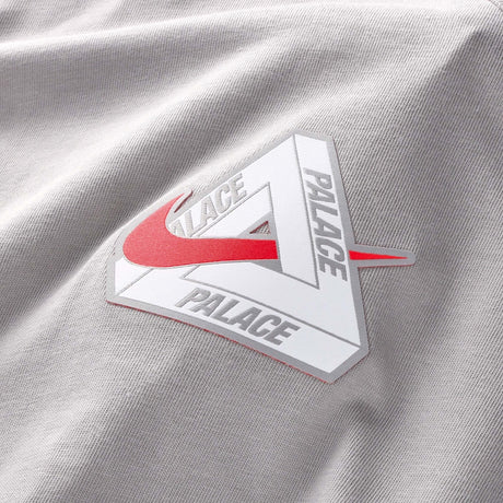 Nike Palace x England T-shirt in pewter grey, featuring England branding and a comfortable fit, worn by a person.