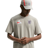 England Nike x Palace Pewter Grey T-shirt featuring Nike and Palace logos, casual fit, and soft fabric.