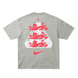 England Nike x Palace premium T-shirt in pewter grey, featuring Nike and Palace branding and a stylish casual fit.
