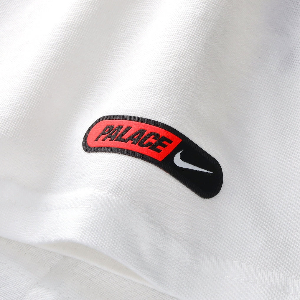 White Nike Palace x England T-shirt featuring England branding and a relaxed fit, displayed on a flat surface.