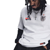 White Nike Palace x England T-shirt with England logo and Nike branding, displayed flat on a neutral background.