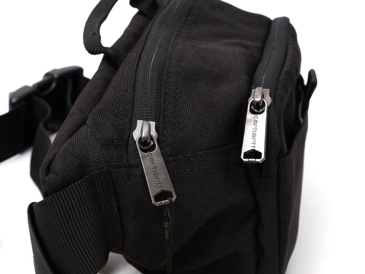 Black Carhartt Classic Waist Bag with adjustable strap and multiple compartments for convenient carrying.