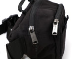 Black Carhartt Classic Waist Bag with adjustable strap and multiple compartments for convenient carrying.