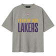 Fear of God Essentials X Lakers NBA 90s heavyweight tee in concrete, unisex apparel featuring Lakers logo and vintage-inspired design.