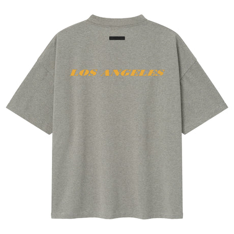 Fear of God Essentials Lakers NBA 90s Heavyweight Tee in concrete, unisex basketball-inspired t-shirt with Lakers logo and vintage style.