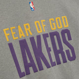 Fear of God Essentials Lakers NBA 90s heavyweight tee in concrete, unisex apprel featuring Los Angeles Lakers logo and vintage design.