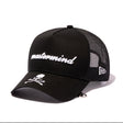 Black Mastermind Japan X New Era 9FORTY A-Frame trucker cap with logo, casual streetwear style, front view.