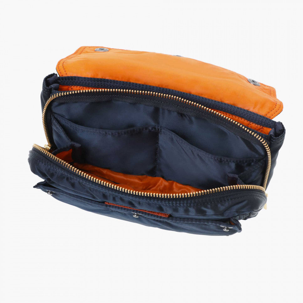 Porter Yoshida Japan Tanker Envelope Bag in navy with leather trim, showcasing its sleek, compact design and durable fabric.