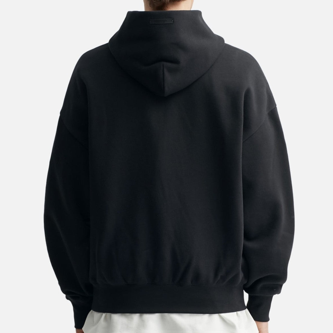 Black Fear of God Essentials NBA hoodie with logo detail, casual fit, and soft fabric, displayed on a plain background.