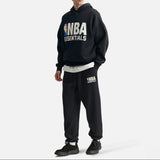 Black Fear of God Essentials X NBA sweatpants with logo details, relaxed fit, made of soft cotton fabric, casual athletic wear.