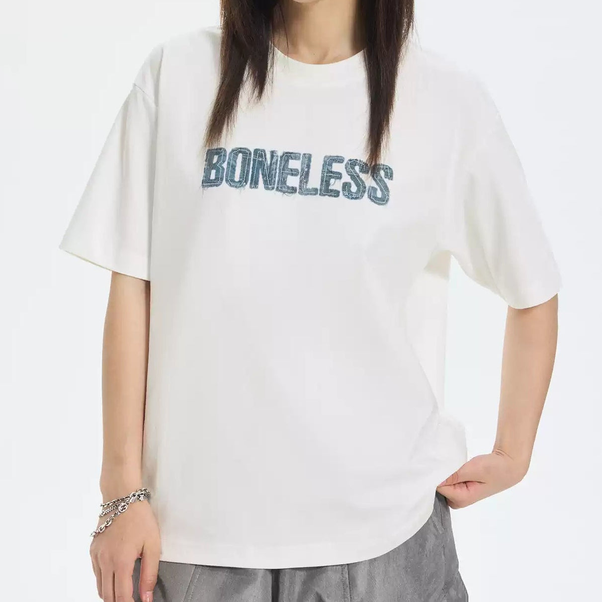 White Boneless faux denim applique logo tee shirt with modern casual style, featuring a denim patch on the front.