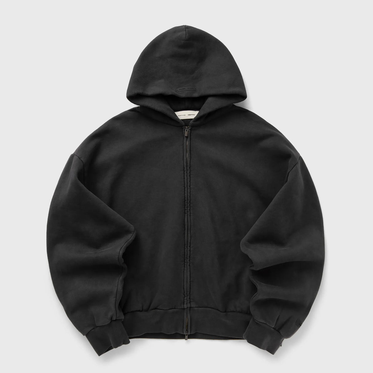 Fear Of God Essentials logo zip-up hoodie in vintage black, featuring a classic design and front logo detail.