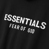 Fear Of God Essentials zip-up hoodie in black and white with logo, casual apparel featuring front zipper and comfortable fit.