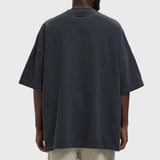 Fear of God Essentials Training 90s Heavyweight Tee in Iron Grey, showing the relaxed fit and soft heavyweight fabric.