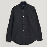 Black Polo Ralph Lauren classic fit Oxford long sleeve shirt displayed on a hanger, showcasing its tailored collar and button-down front.