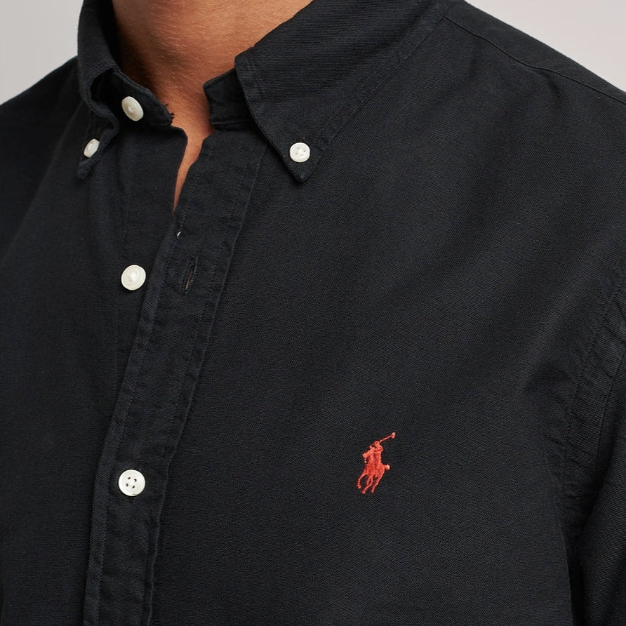 Black Polo Ralph Lauren classic fit long sleeve Oxford shirt, shown flat with collar and button-down front.