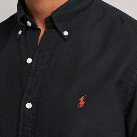 Black Polo Ralph Lauren classic fit long sleeve Oxford shirt, shown flat with collar and button-down front.