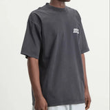 Balenciaga Masking Tape Tee in black, featuring a casual crew neck design and graphic print, styled on a model.