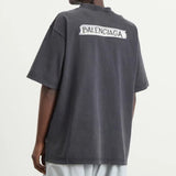 Black Balenciaga Masking Tape Tee, casual apparel with a relaxed fit, featuring distinctive branding and design details.