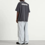 Black Balenciaga Masking Tape Tee, casual apparel with bold graphic design, displayed flat on a white background.