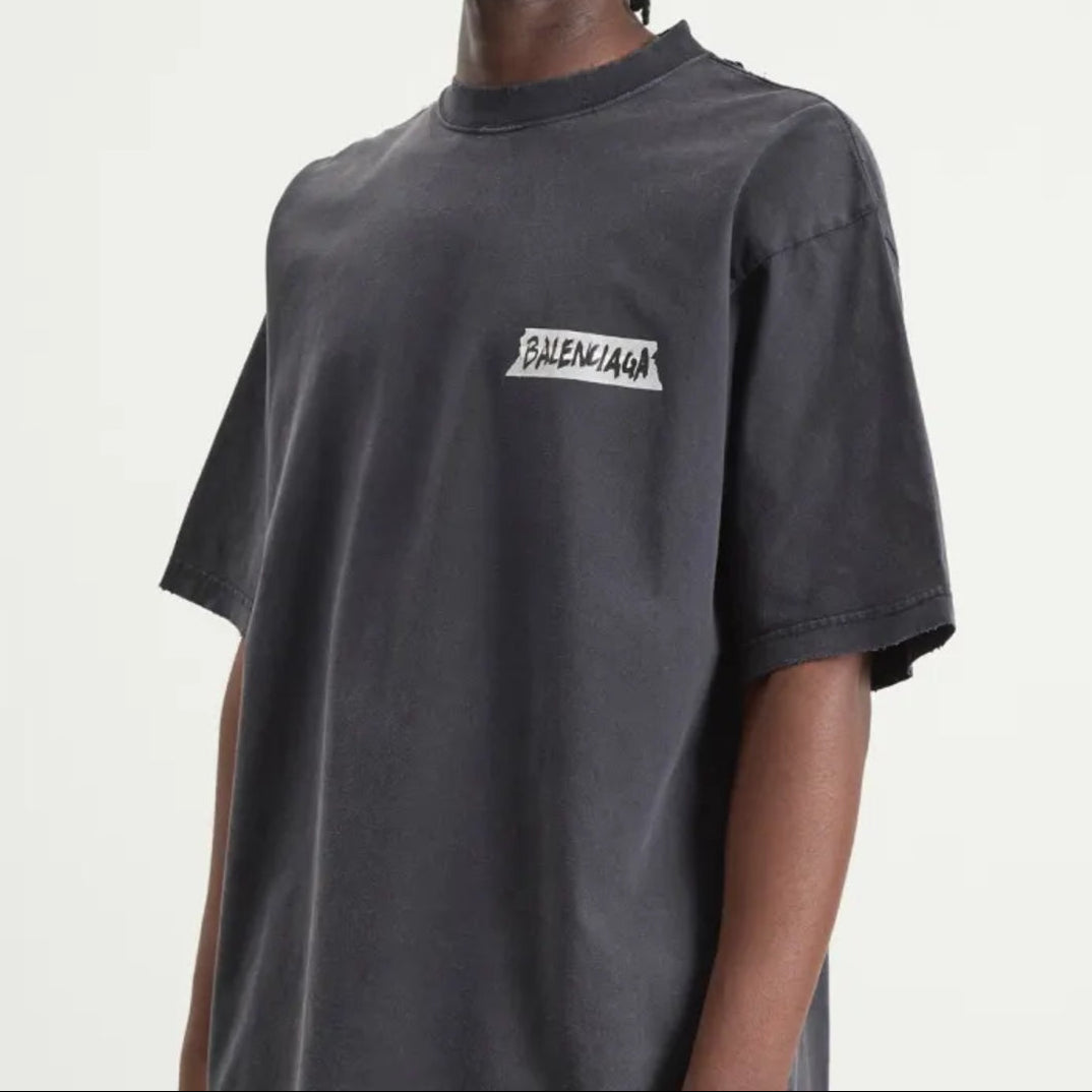 Black Balenciaga Masking Tape Tee shirt with graphic design, showcasing a casual, stylish apparel piece from the luxury brand.