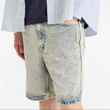 AAPE by Bathing Ape loose fit denim shorts with faded wash and classic five-pocket design, displayed on a plain background.