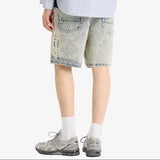 AAPE by Bathing Ape loose fit denim shorts with distressed details and classic branding, displayed on a neutral background.