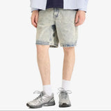 AAPE by Bathing Ape loose fit denim shorts with distressed details and classic five-pocket design on a plain background.