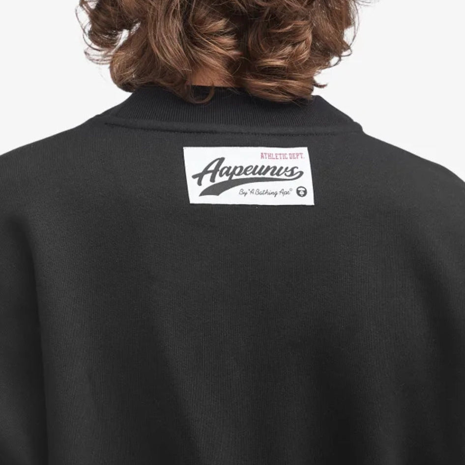 AAPE by Bathing Ape UNVS cardigan in black and beige with logo details, displayed flat on a white background.