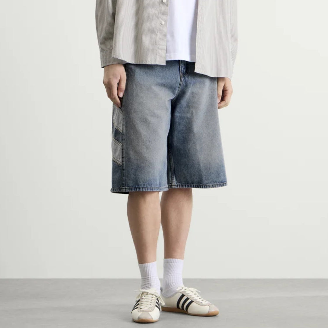 Adidas denim shorts in indigo color, casual apparel with a classic fit and visible stitching, perfect for relaxed summer style.