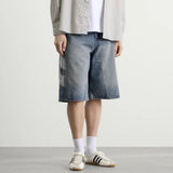 Adidas denim shorts in indigo color, casual apparel with a classic fit and visible stitching, perfect for relaxed summer style.