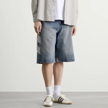 Adidas denim shorts in indigo color, casual apparel with a classic fit and visible stitching, perfect for relaxed summer style.