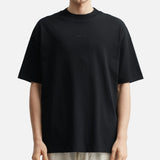 Fear of God Essentials metallic logo black classic T-shirt, black cotton apparel with brand logo detail, front view.