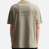 Fear of God Essentials metallic logo classic fit tee in Abbey Stone, showing the soft fabric and subtle logo detail.