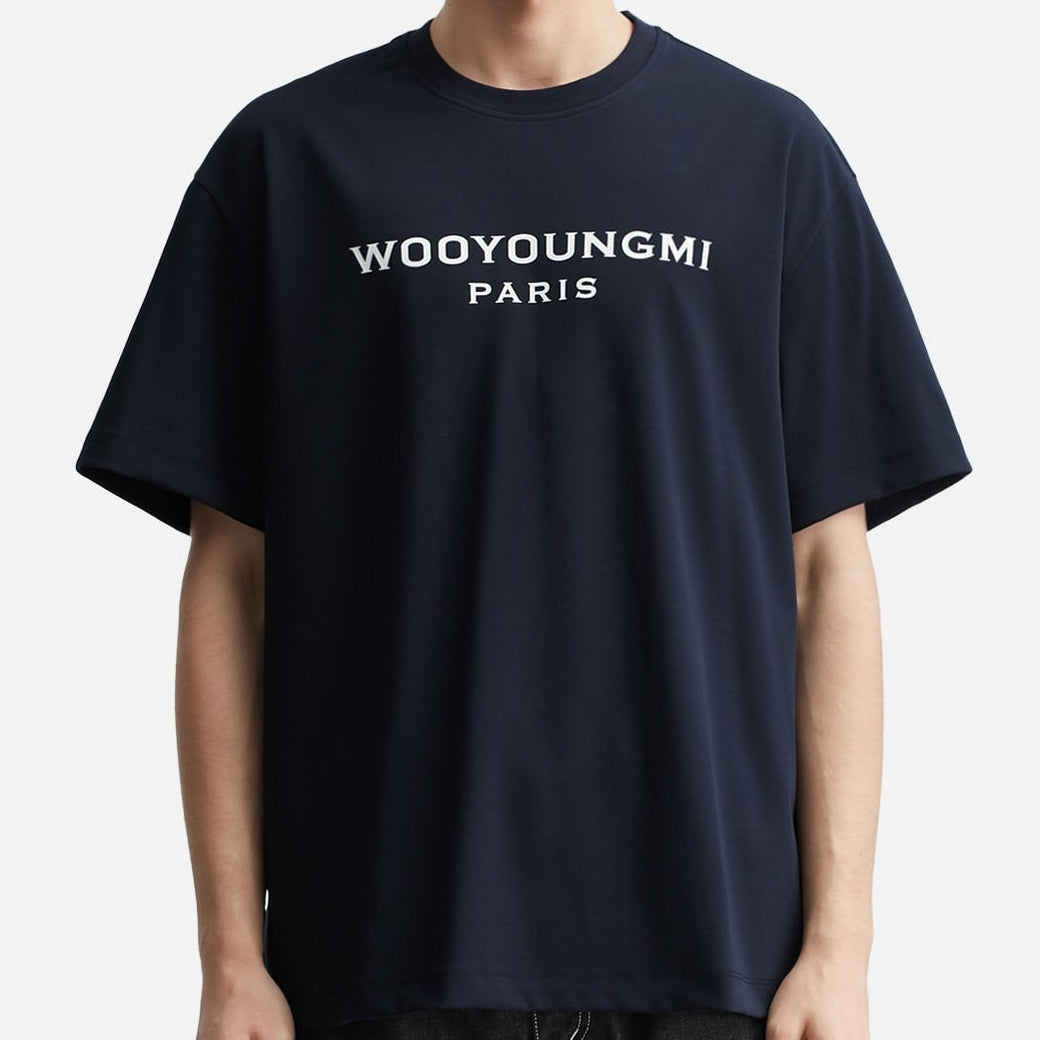 Dark navy Wooyoungmi front logo tee shirt, casual apparel with bold logo design, displayed on a plain background.